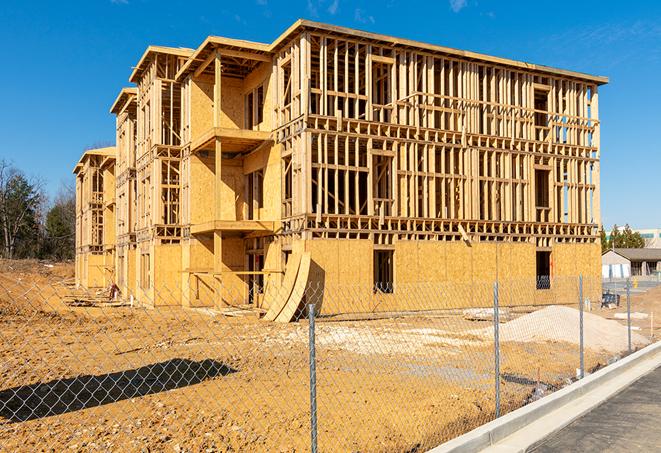 a temporary chain link fence in front of a building under construction, ensuring public safety in Martinez CA